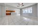 Open living area adjacent to the kitchen, featuring tile flooring and a ceiling fan at 1079 Berkeley Dr, Kissimmee, FL 34744
