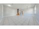 Living room with tile floors, wooden staircase, and front door access at 1079 Berkeley Dr, Kissimmee, FL 34744