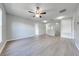Large, open living area with wood-look floors and a ceiling fan at 1079 Berkeley Dr, Kissimmee, FL 34744
