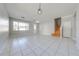 Living room featuring tile flooring, a staircase, and windows at 1079 Berkeley Dr, Kissimmee, FL 34744