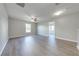 Spacious living room with wood-look flooring and a ceiling fan at 1079 Berkeley Dr, Kissimmee, FL 34744