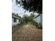 View of the property's backyard access with mature trees and fencing at 116 S 4Th St, Haines City, FL 33844