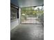 Covered carport with concrete flooring and gated entrance at 116 S 4Th St, Haines City, FL 33844