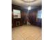 Dining room with wood paneling and tile floors at 116 S 4Th St, Haines City, FL 33844