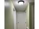 Light-colored hallway with two closed doors at 116 S 4Th St, Haines City, FL 33844
