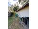 Home's side yard view, showing a utility area and trash cans at 119 Buck Ct, Casselberry, FL 32707