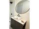 Updated bathroom with a stylish vanity and round mirror at 1411 Florida Ave, Saint Cloud, FL 34769