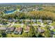 Aerial view showing home's location in a residential neighborhood near a lake at 1416 Wood Lake Cir, St Cloud, FL 34772