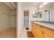 Bathroom with a walk-in shower, double vanity, and closet at 1416 Wood Lake Cir, St Cloud, FL 34772