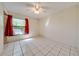 Charming bedroom with tile floors and a large window at 1416 Wood Lake Cir, St Cloud, FL 34772