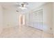 Bright bedroom featuring tile floors and ample closet space at 1416 Wood Lake Cir, St Cloud, FL 34772