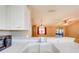 Kitchen features a double sink and a view to the living room at 1416 Wood Lake Cir, St Cloud, FL 34772
