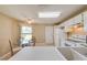 Kitchen with white cabinets and eat-in area at 1416 Wood Lake Cir, St Cloud, FL 34772