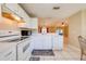 Kitchen with white cabinets, view to living room at 1416 Wood Lake Cir, St Cloud, FL 34772