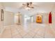 Open concept living room with tile floors and kitchen access at 1416 Wood Lake Cir, St Cloud, FL 34772