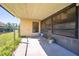 Covered patio with adjacent fenced yard and storage space at 1416 Wood Lake Cir, St Cloud, FL 34772