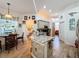 View of the kitchen island, dining area, and surrounding cabinets and appliances at 1646 Dunes Ct, Haines City, FL 33844