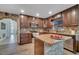 Granite kitchen island and updated cabinetry with a view of the entryway at 2372 Topaz Trl, Kissimmee, FL 34743