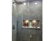 Elegant shower with glass enclosure and built-in shelves at 2526 Bowmer Dr, Kissimmee, FL 34744