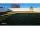Large backyard with grassy area and white vinyl fence at 2672 Harmonia Hammock Rd, Harmony, FL 34773