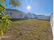 Fenced backyard with grassy area and partial view of house at 2672 Harmonia Hammock Rd, Harmony, FL 34773