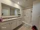 Elegant bathroom with double sinks and a large mirror at 2672 Harmonia Hammock Rd, Harmony, FL 34773