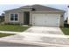One-story house with attached garage and well-maintained lawn at 2672 Harmonia Hammock Rd, Harmony, FL 34773