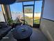 Cozy screened porch with seating area and view of backyard at 2672 Harmonia Hammock Rd, Harmony, FL 34773