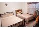 Bedroom with twin beds and window at 326 Dinner Lake Ct, Lake Wales, FL 33859