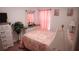 Charming bedroom with floral bedding and plenty of light at 326 Dinner Lake Ct, Lake Wales, FL 33859