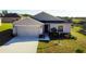 One-story house with a two-car garage and well-manicured lawn at 326 Dinner Lake Ct, Lake Wales, FL 33859