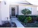 Inviting front door entrance with landscaped walkway and garden at 326 Dinner Lake Ct, Lake Wales, FL 33859
