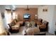 Living room with sectional sofa, two armchairs, and a coffee table at 326 Dinner Lake Ct, Lake Wales, FL 33859