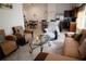 Living room with sectional sofa, two armchairs, and view of kitchen and dining area at 326 Dinner Lake Ct, Lake Wales, FL 33859