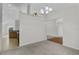 Bright dining room with carpet flooring and view into kitchen at 3362 Winchester Estates Cir, Lakeland, FL 33810