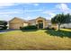 Tan house with a two car garage and landscaping at 3362 Winchester Estates Cir, Lakeland, FL 33810