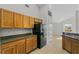 Kitchen boasts wood cabinets, granite countertops, and a black refrigerator at 3362 Winchester Estates Cir, Lakeland, FL 33810