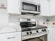 Close-up of stainless steel appliances and quartz countertop in the renovated kitchen at 666 Avenue B Sw, Winter Haven, FL 33880