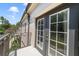 Private balcony with double doors and views of lush greenery at 701 Westpark Way # 202, Celebration, FL 34747