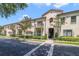 Two-story building with balconies, landscaping, and a tree-lined street at 701 Westpark Way # 202, Celebration, FL 34747