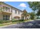 Townhouses with balconies, manicured landscaping, and a tree-lined street at 701 Westpark Way # 202, Celebration, FL 34747