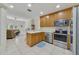 Well-equipped kitchen with stainless steel appliances and wood cabinets at 701 Westpark Way # 202, Celebration, FL 34747