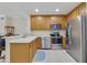 Modern kitchen with stainless steel appliances and light oak cabinets at 701 Westpark Way # 202, Celebration, FL 34747