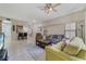 Spacious living room with tile floors, couches, and access to kitchen at 701 Westpark Way # 202, Celebration, FL 34747