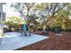 Large backyard with patio, dining area, and lush landscaping at 803 E 11Th Ave, New Smyrna Beach, FL 32169