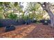 Landscaped backyard with privacy fence, lighting, and raised garden beds at 803 E 11Th Ave, New Smyrna Beach, FL 32169
