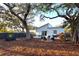 Private backyard oasis with fire pit and plenty of shade trees at 803 E 11Th Ave, New Smyrna Beach, FL 32169
