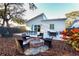 Relaxing backyard with fire pit, patio furniture, and wooden privacy fence at 803 E 11Th Ave, New Smyrna Beach, FL 32169
