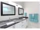 Modern bathroom with double vanity and granite countertop at 803 E 11Th Ave, New Smyrna Beach, FL 32169