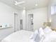 Spacious bedroom with a queen bed and access to a full bathroom at 803 E 11Th Ave, New Smyrna Beach, FL 32169